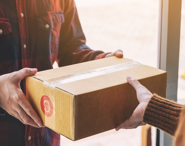 woman-receiving-parcel-box-from-delivery-man-at-th-2024-11-27-11-32-06-utc 1 (1)