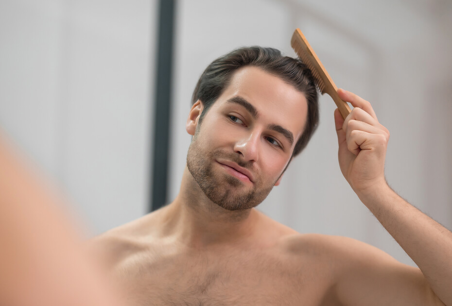 young-handsome-man-brushing-his-hair-and-looking-c-2024-10-16-23-23-08-utc (1) (1)
